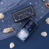 Tsuki Gentle Giant washi tapes on deep blue background and white net + seashells scattered around the washi tape set