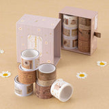 Tsuki Light Academia washi tape rolls stacked in a pyramid with the open drawer box in the background