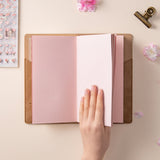 Photo of Hinoki travel notebook on table with cup of tea