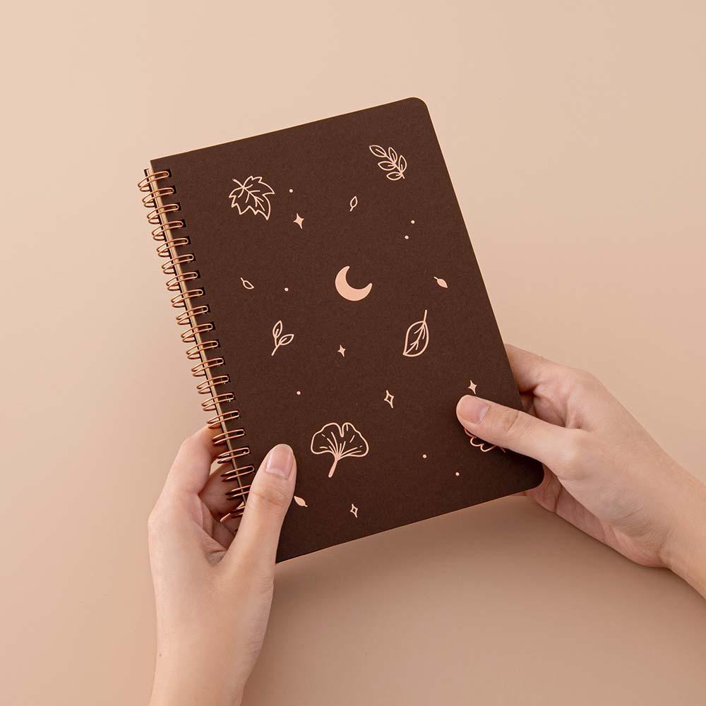 Tsuki ‘Maple Dreams’ Kraft Paper Ringbound Bullet Journal held in hands in beige background
