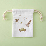 Close up of the Tsuki ‘Matcha Matcha’ Tote Bag free matching drawstring pouch on matcha green background