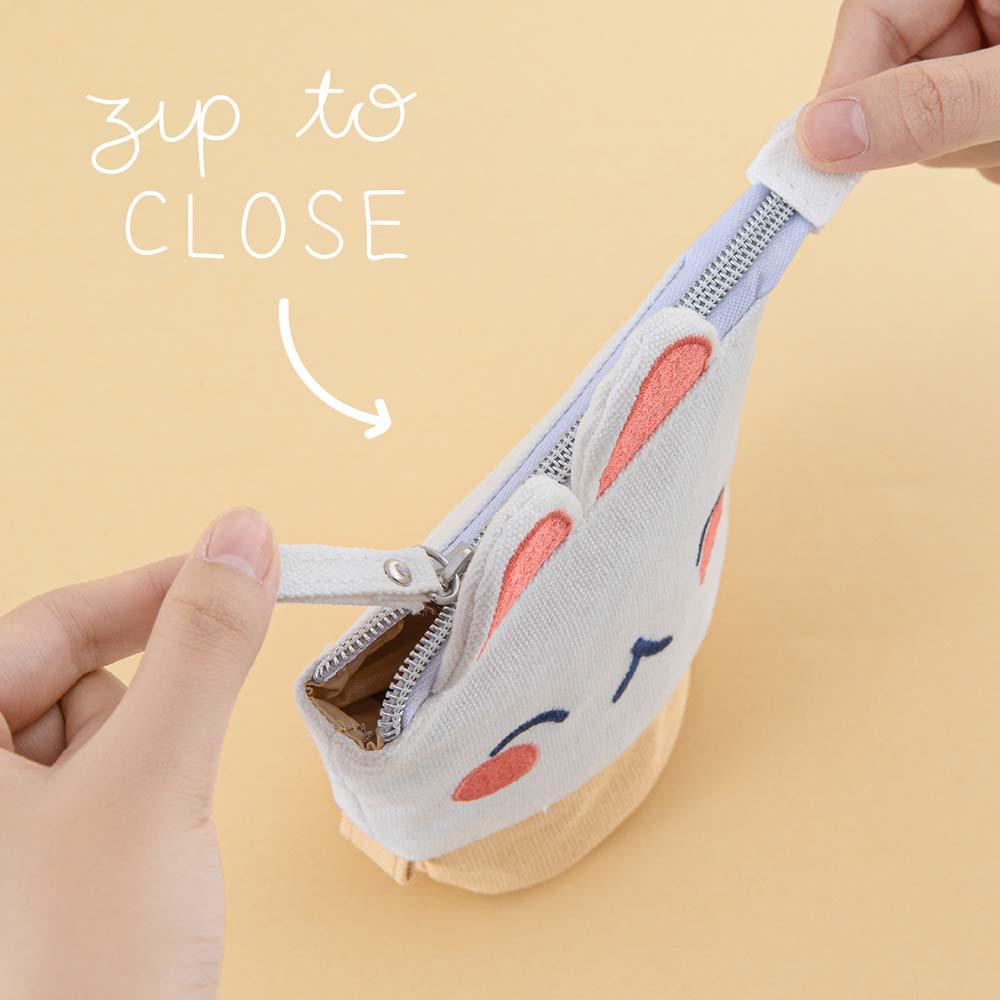 Tsuki ‘Four Seasons’ Embroidered Pop-Up Pencil Case by Notebook Therapy x Milkkoyo in kitty with zip to close held in hands on honey yellow background