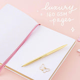 Open page spread of Tsuki Cloud White ‘Flutter + Dream’ Limited Edition Bullet Journal by Notebook Therapy x Pelinkan with luxury 160GSM pages and free butterfly bookmark gift with gold pen and butterflies on pastel pink background