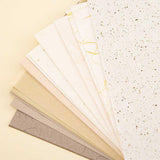 Close up of Tsuki Mixed Scrapbook Paper Pack on cream background