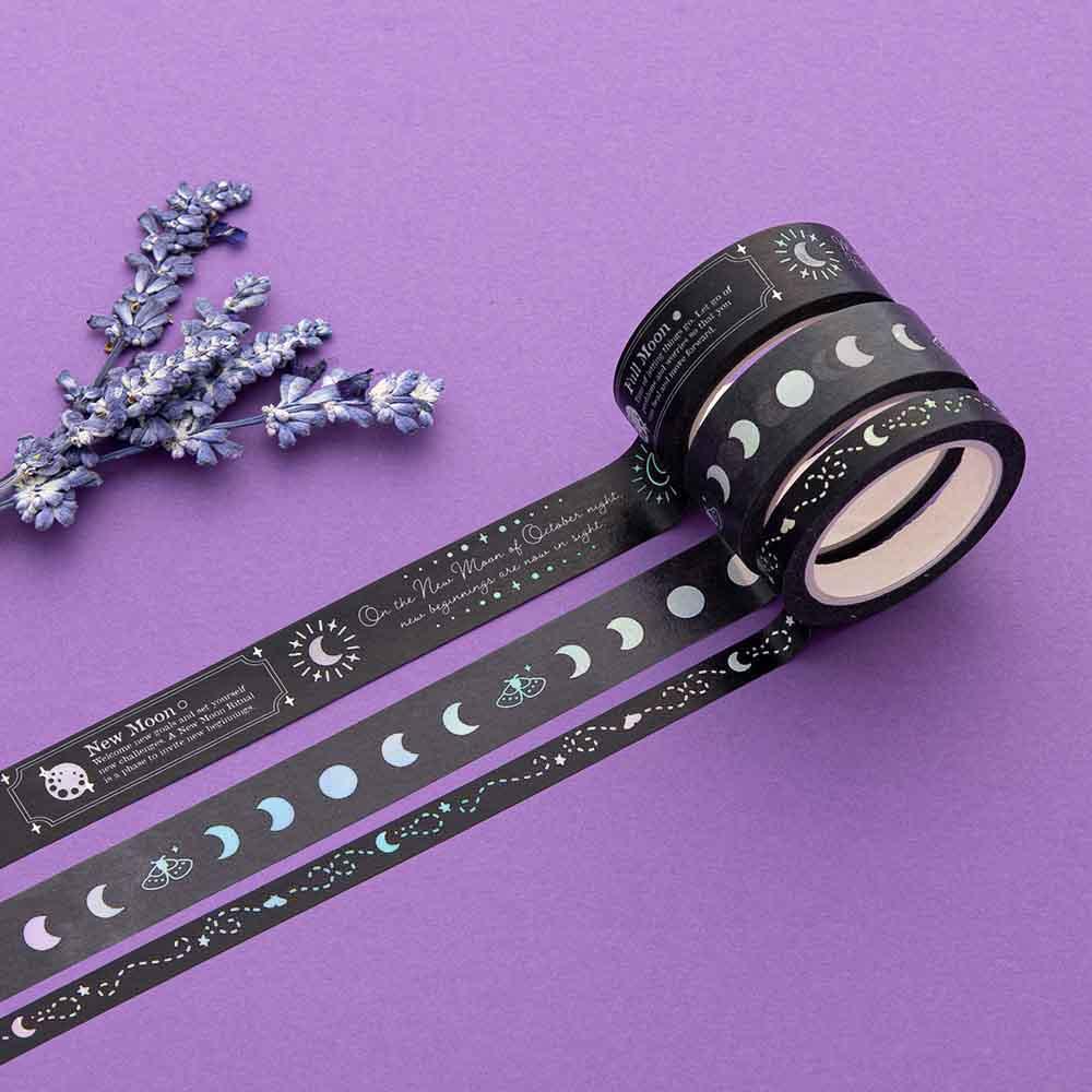 Close up of Tsuki ‘Moonlit Spell’ Washi Tape with lavender sprigs on purple background