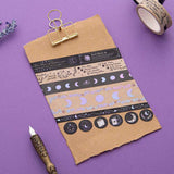 Tsuki ‘Moonlit Spell’ Washi Tape Set on kraft paper clipboard with lavender sprigs and black feather quill on purple background