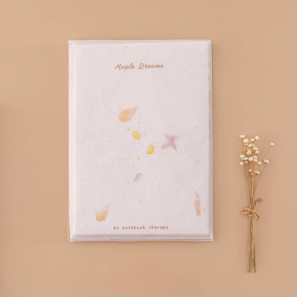 Tsuki Handmade Petal Paper Pack in glassine envelope packaging with dried flowers on beige background
