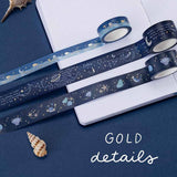 3 rolls of gentle giant washi tape on a dotted bullet journal paper with the words ‘gold details’ written in white