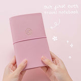 Our first ever Tsuki ‘Sakura Journey’ Limited Edition Travel Notebook held in hands in pink background